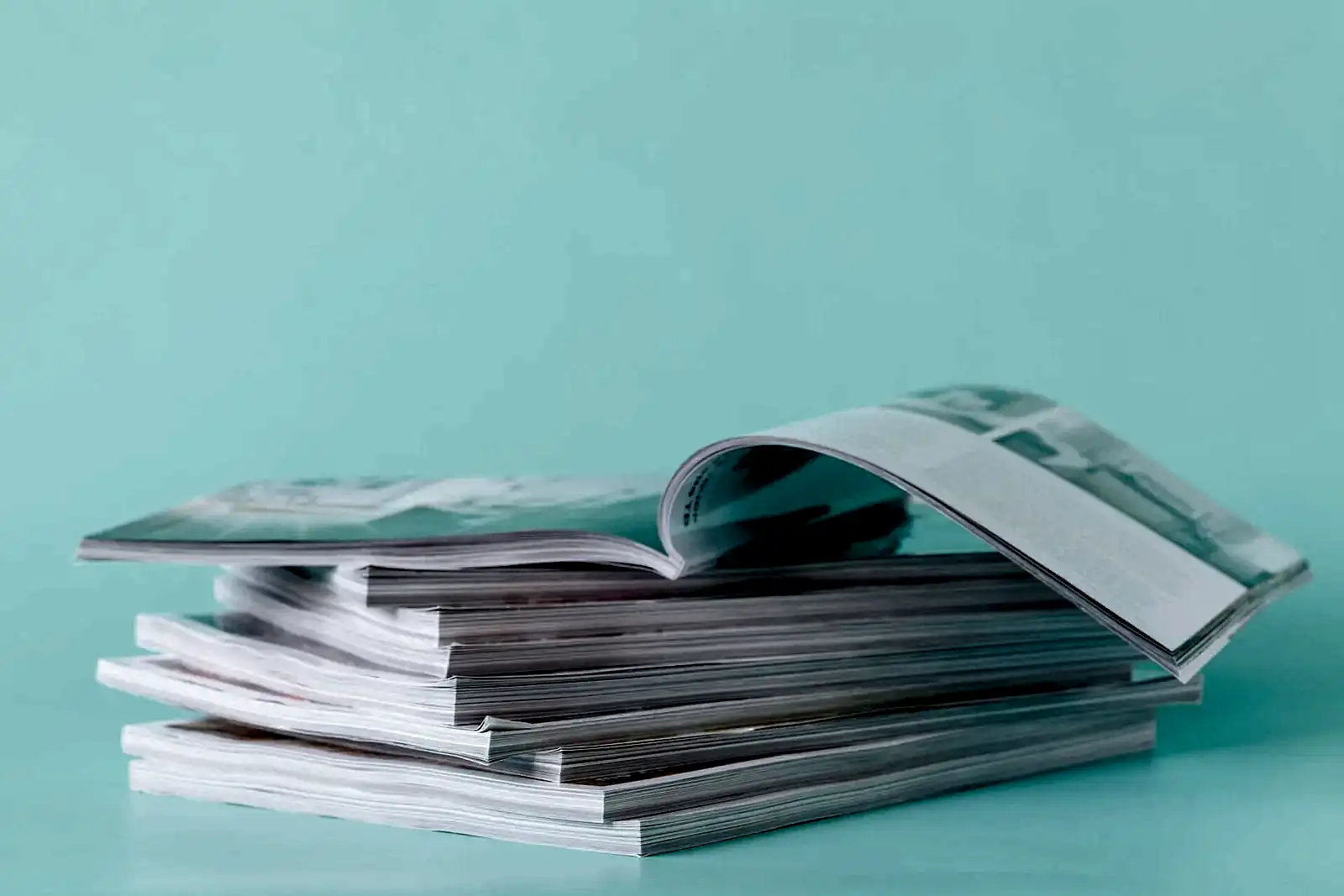 side view of a stack of magazines with glossy paper